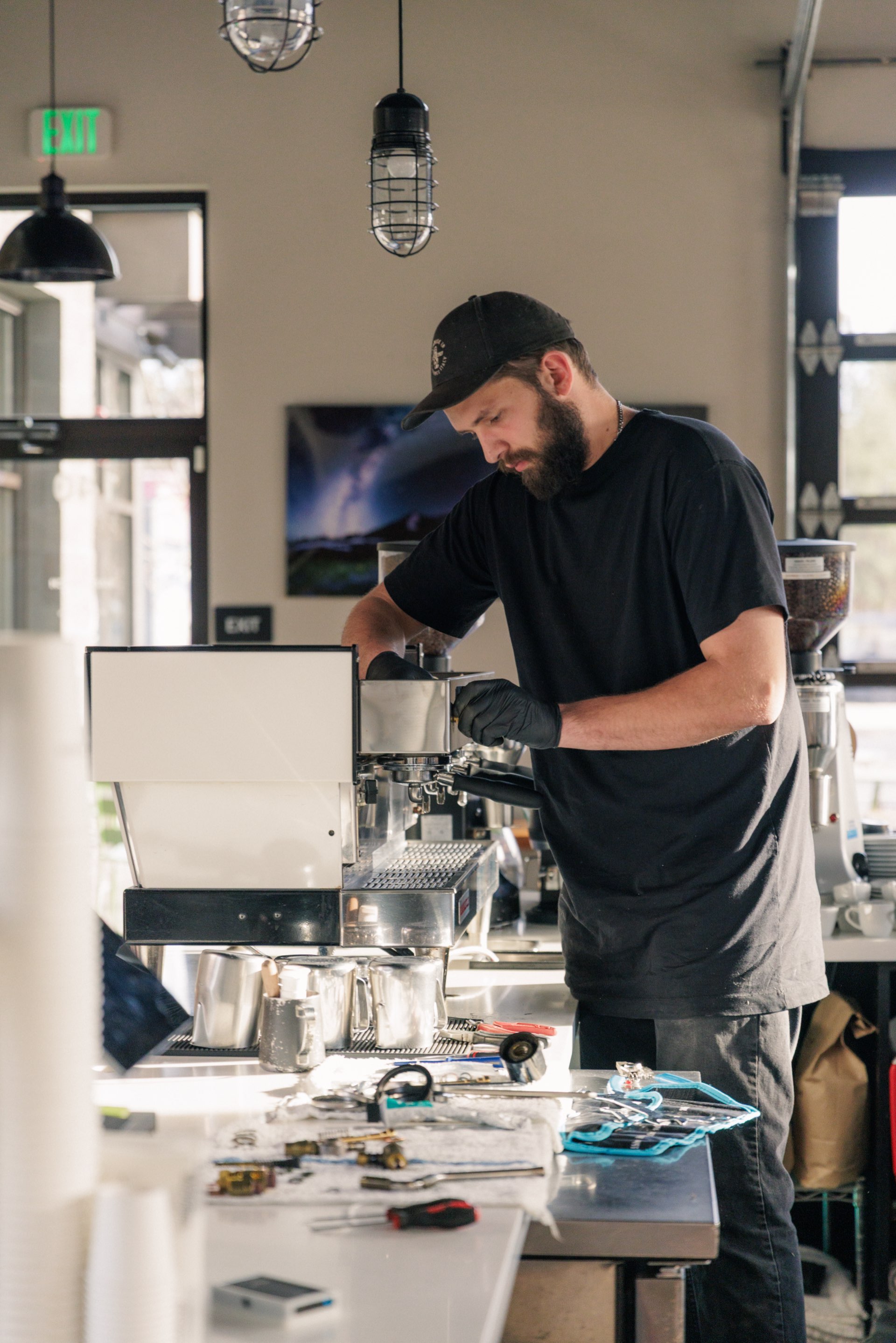 Cameron Baker working on espresso equipment